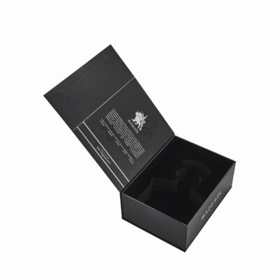 Open black Hadesis XO flip top cognac box showing silver foil interior text and black EVA foam bottle cradle