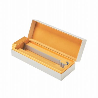Upright closed Ritz Paris Montaña velvet lined wine gift box in white linen specialty paper with gold foil stamping and gold card edge seam