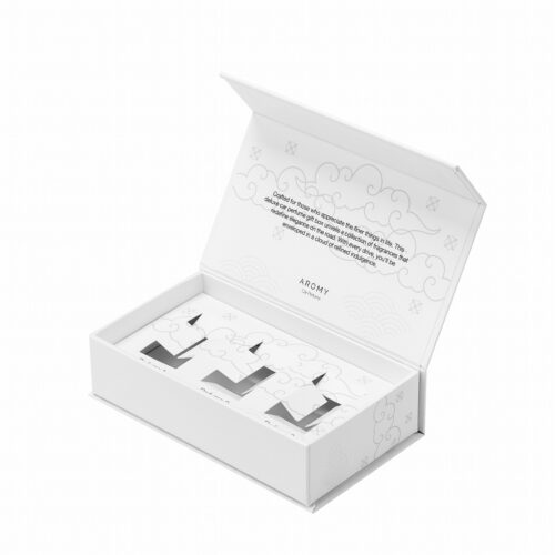 White custom magnetic perfume box open showing rigid book-style flap and minimalist cloud patterns