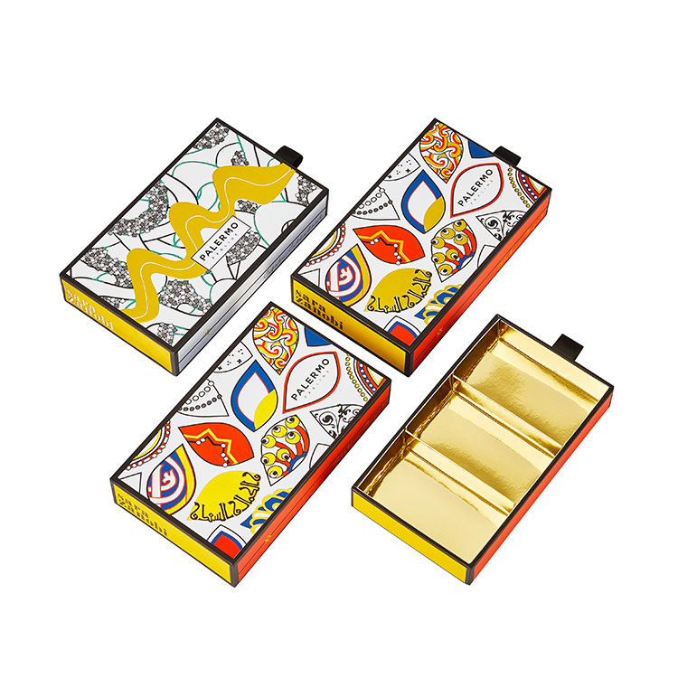 Folded gold cardstock inserts engineered with food-grade materials inside chocolate rigid drawer boxes.