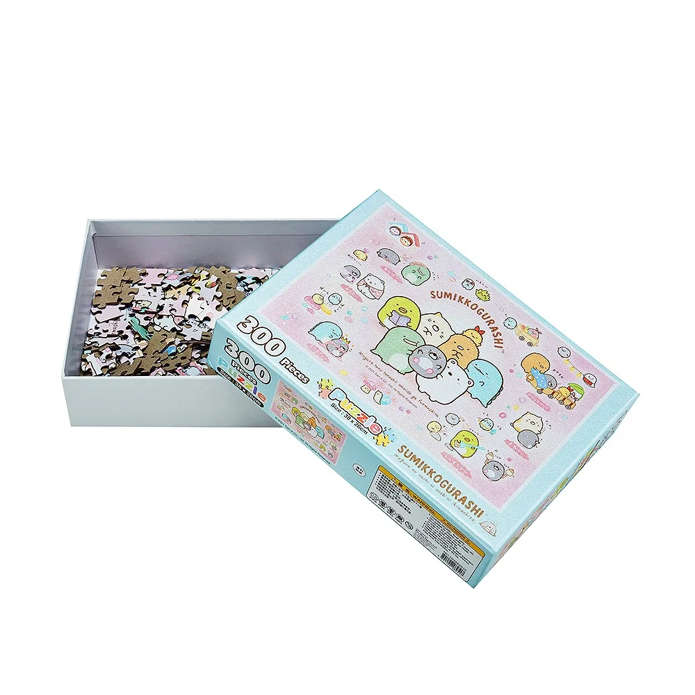 Opened two-piece lid and base puzzle box holding printed jigsaw pieces