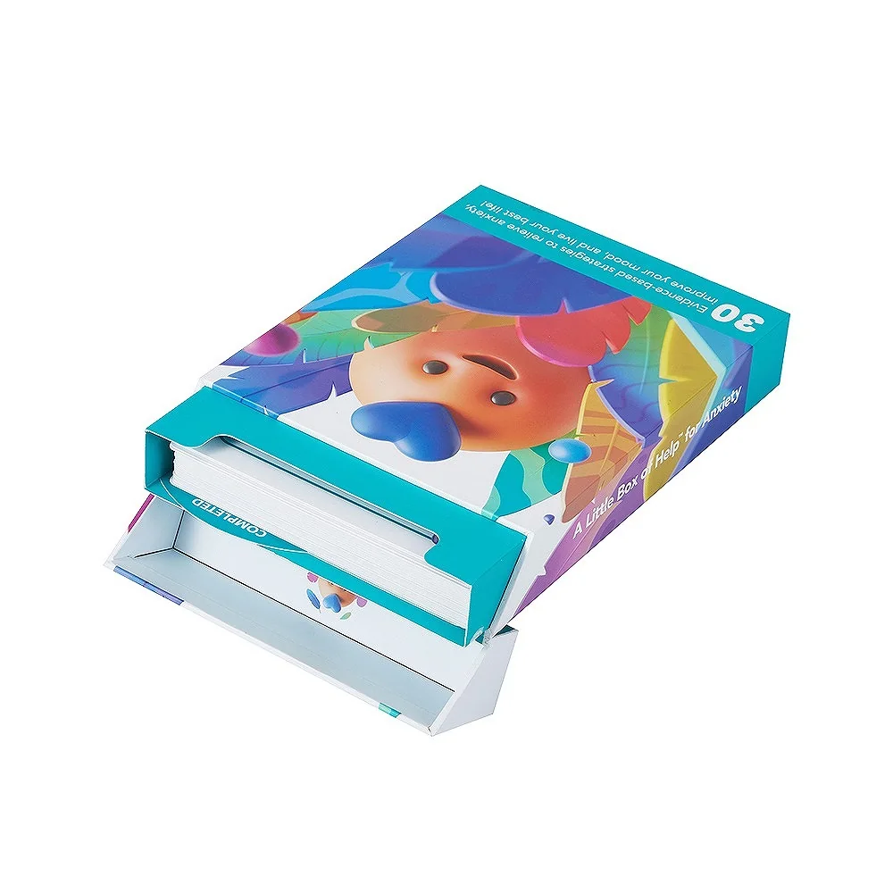 Flip-open end flap on illustrated card carton revealing a stack of printed activity cards